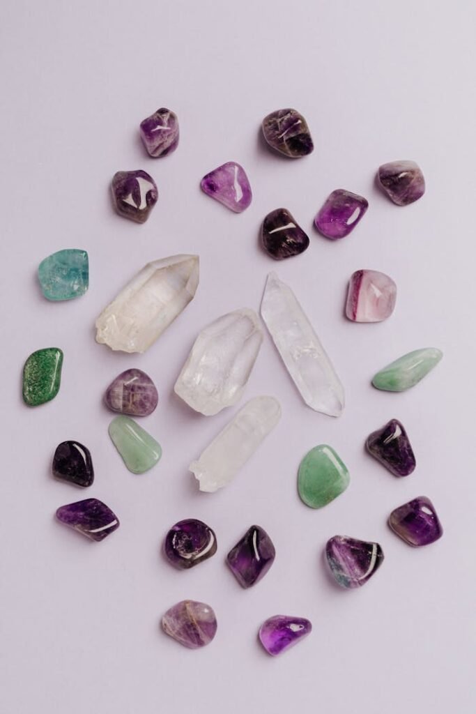 A variety of polished gemstones in vibrant colors arranged on a white surface.