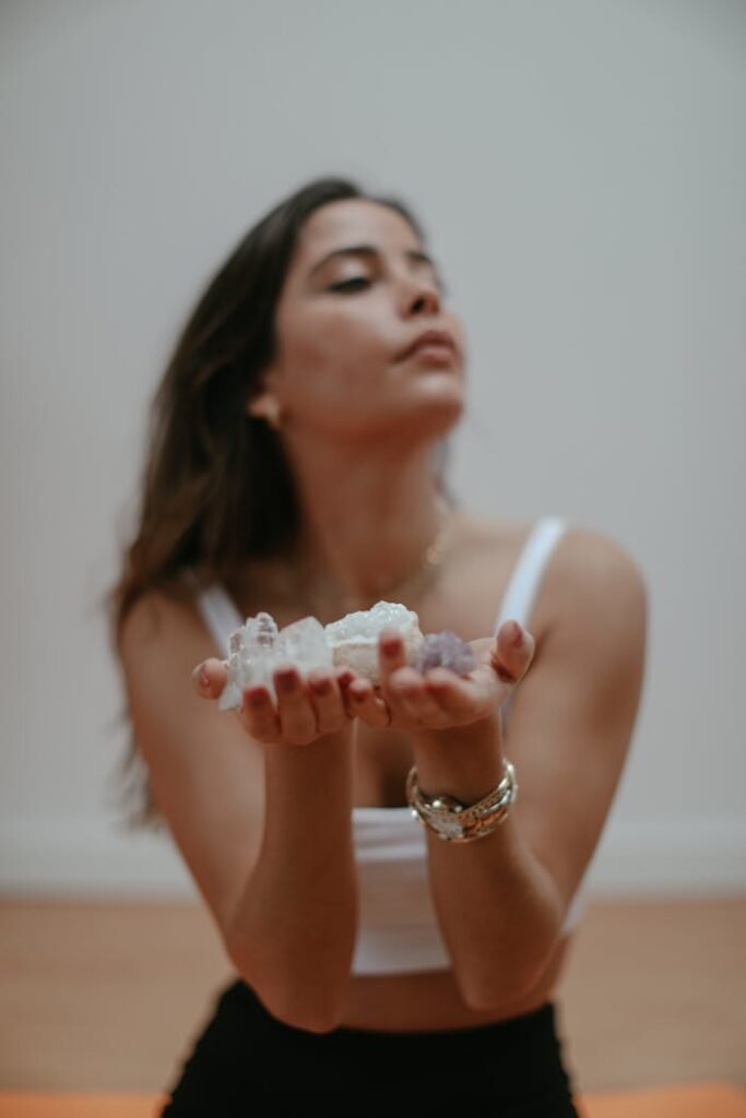 A serene young woman holding healing crystals, symbolizing spirituality and inner peace.