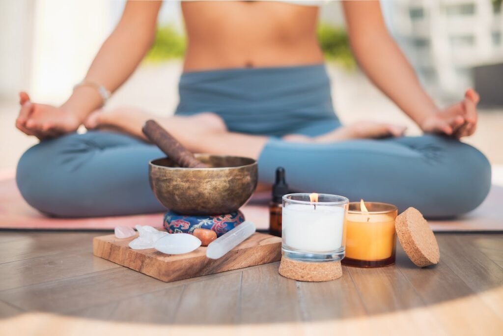 A serene meditation setup with crystals, candles, and a Tibetan singing bowl.